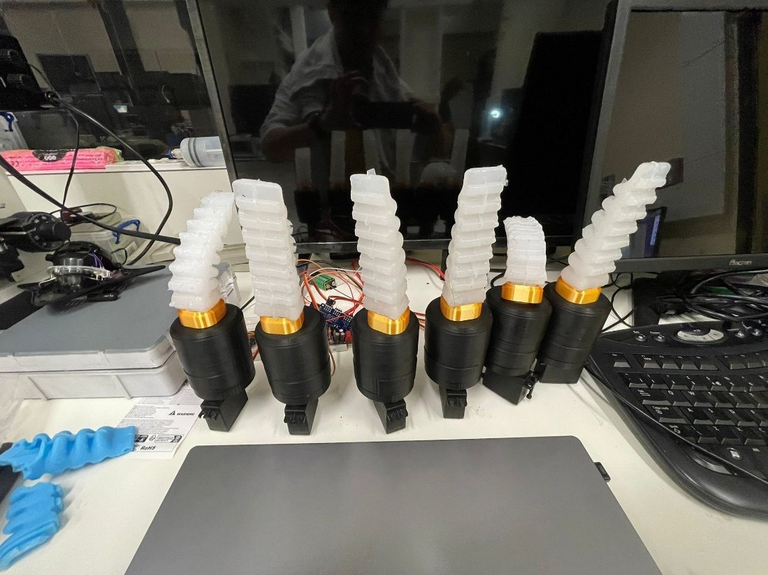 The cast silicone limbs lined up on the bench with their servos